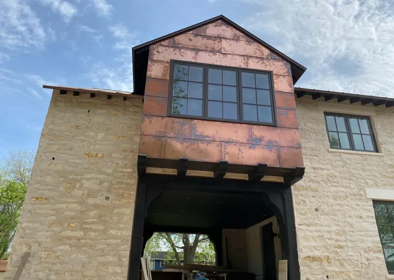 Copper metal panel facade on a stone building for Roof Repair in Glenvar Heights