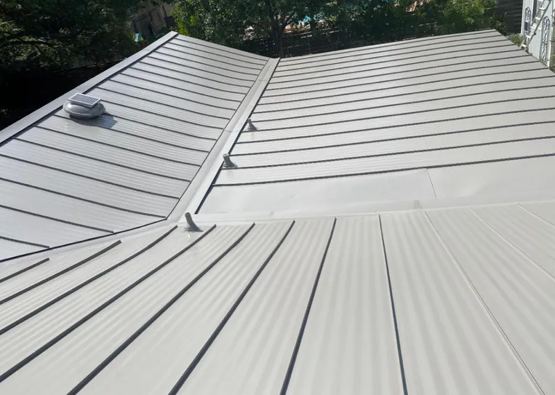 Solar attic fan installed on a metal roof for Roof Ventilation in Glenvar Heights